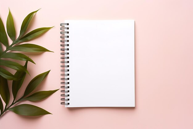 Open Notebook and Plant on Pink Background