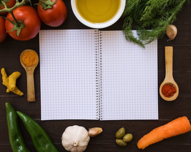 Open notebook surrounded by food ingredients.