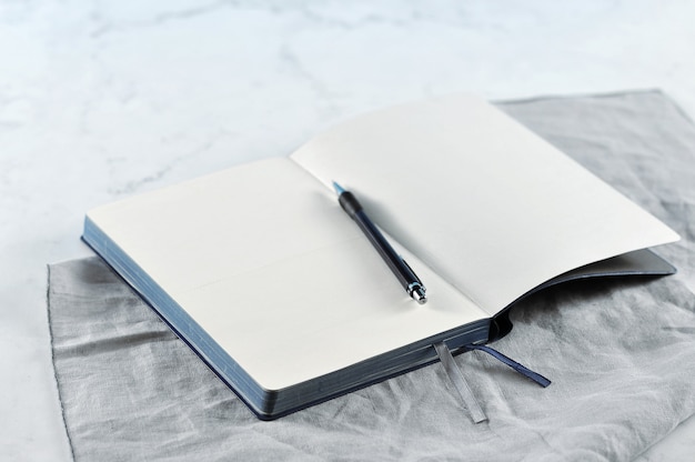 Open notebook on white marble  