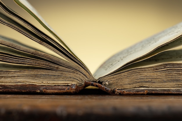 An open old Bible illuminated by a warm light Studio shot copy space