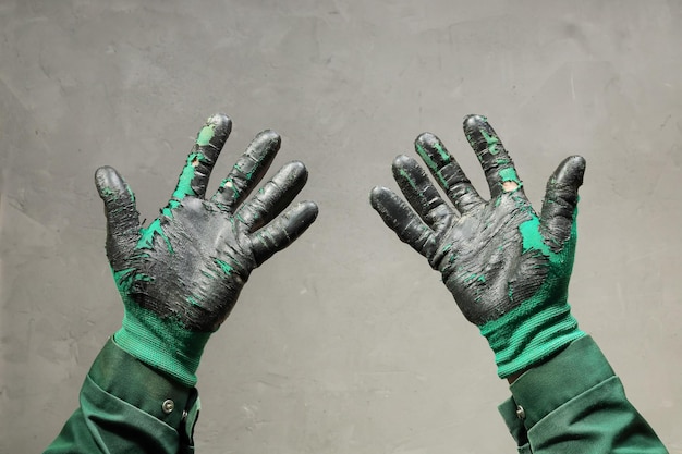 Open palms of hands in worn workers gloves protection against damage during operation