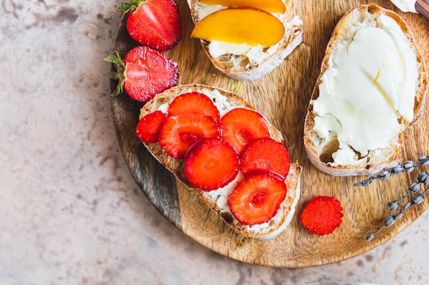 Open sandwiches with artisan bread and cream cheese nectarines strawberries and honey