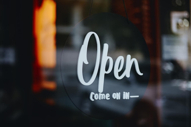 Open sign on cafe or restaurant hang on glass door at entrance