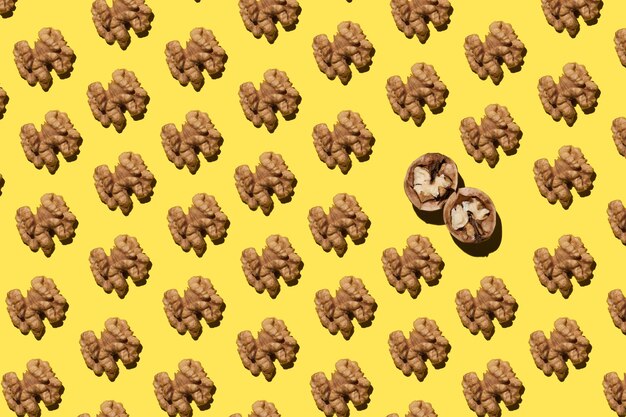 Open walnuts Pattern on a yellow background High quality photo