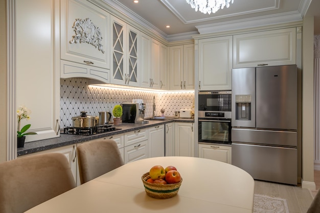 Openconcept kitchen with a beige color scheme and classic design elements