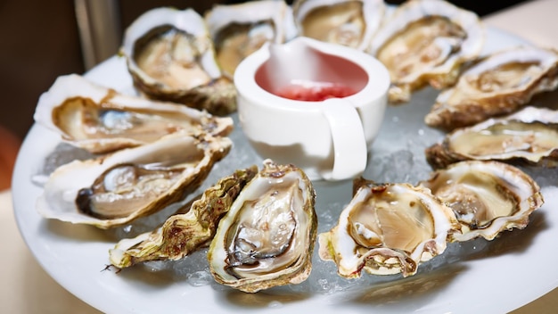 Opened fresh oysters with lemon on dish Shallow dof