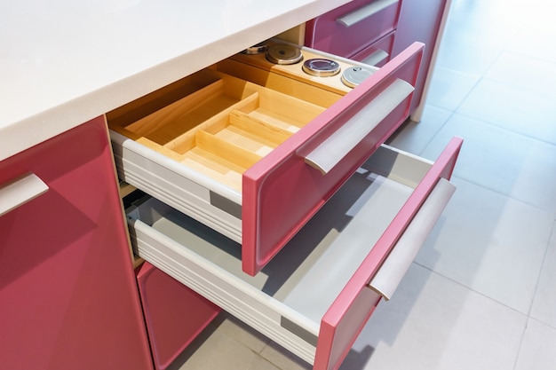 Opened kitchen drawer with plates inside, a smart solution for kitchen storage and organizing