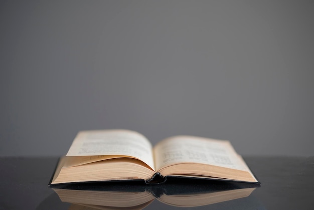 A opened old book on the table as the symbol of wisdom and knowledge education concept