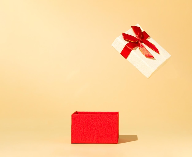 Opened red gift box on beige background New Year creative concept 8 March or Day idea Copy space