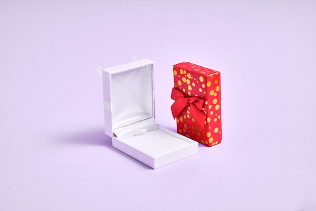 Opened white empty ring box and golden red box. Proposal in christmas. Valentines day jewelry