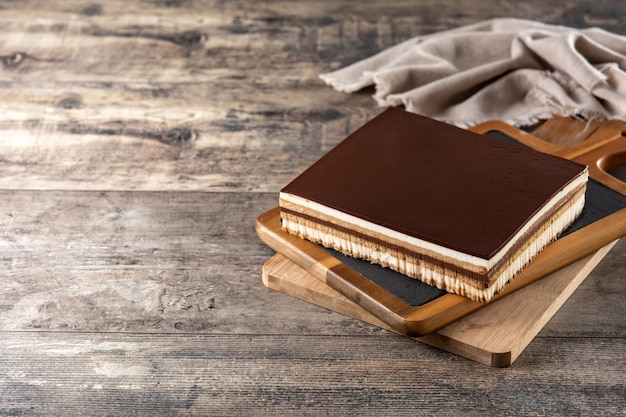 Opera cake dessert slice on wooden table