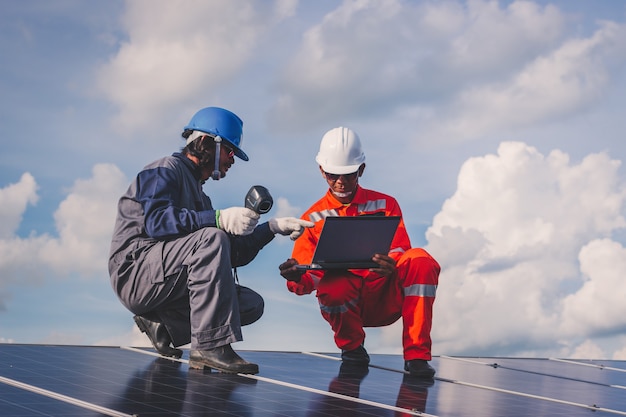 Operation and maintenance in solar power plant ; engineering team working on checking and maintenance in solar power plant ,solar power plant to innovation of green energy for life