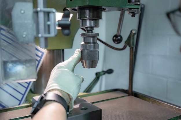 Photo the operator operates a mechanically controlled drilling machine