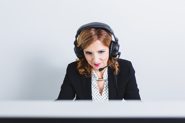 Operator woman agent with headsets working in a call centre.