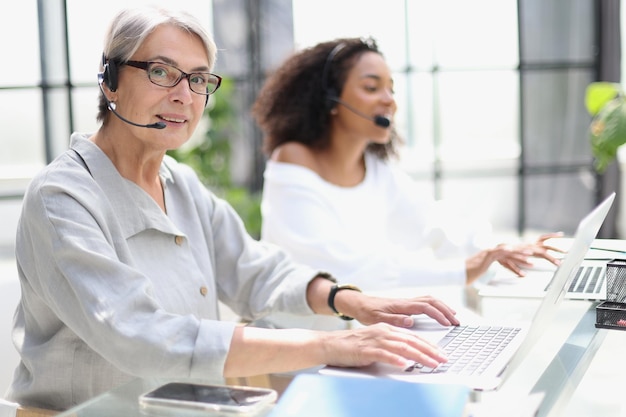 Operator woman agent with headsets working in a call centre