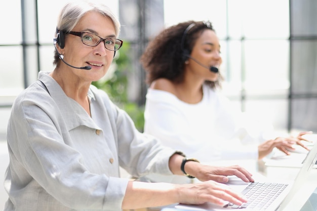 Operator woman agent with headsets working in a call centre