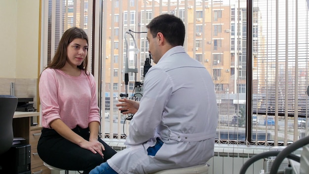 Ophthalmology treatment young woman having a consultation with an optometry doctor