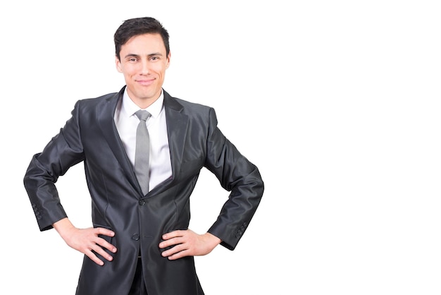 Optimistic man in suit with hands on waist