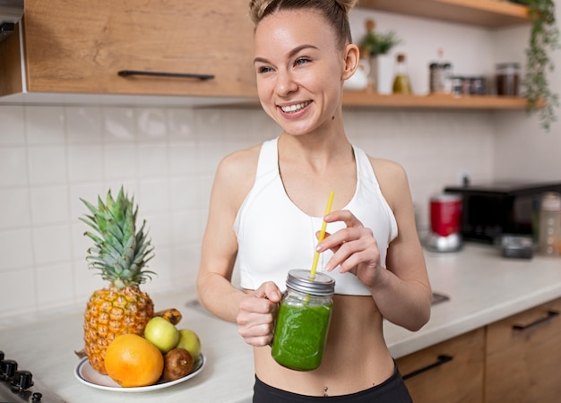 Optimistic sportswoman enjoying healthy drink