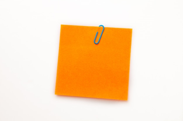 Orange adhesive note with a paperclip