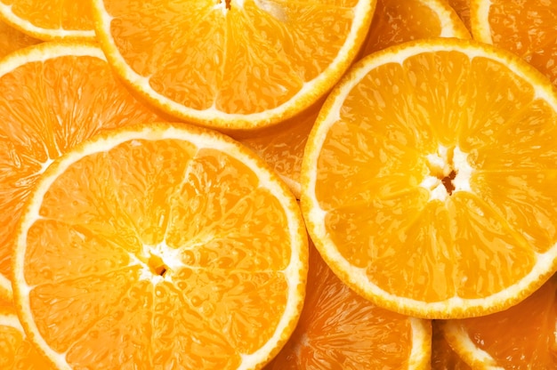 Orange background. Round juicy orange slices, top view.