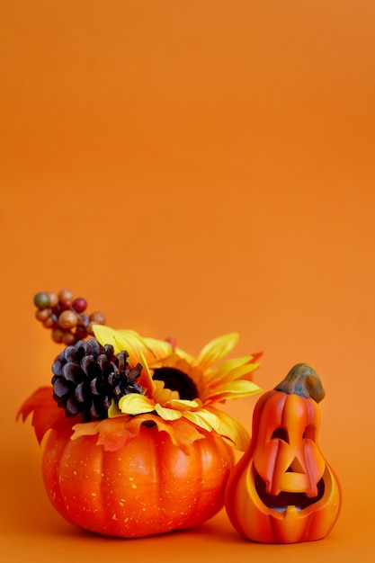 Orange background with decorative items for halloween. Halloween scary pumpkin