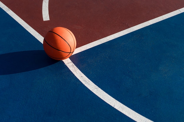 An orange ball on basketball court