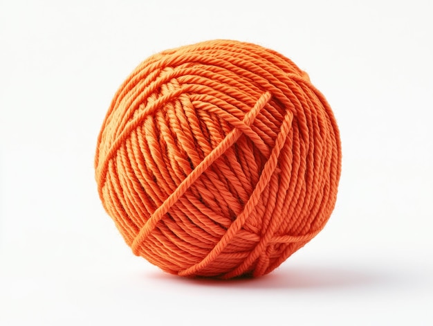 Photo orange ball of yarn tightly wound with texture isolated on white background