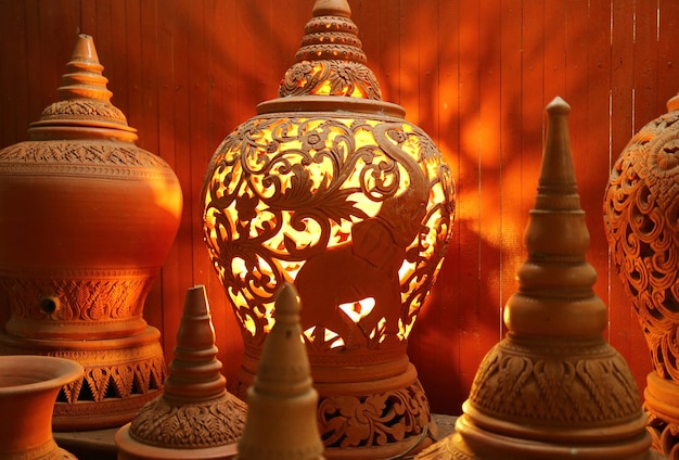 Orange brown unglazed clayware Lamp with an intricate patterns of Koh Kret pottery, Koh Kret Island, Thailand