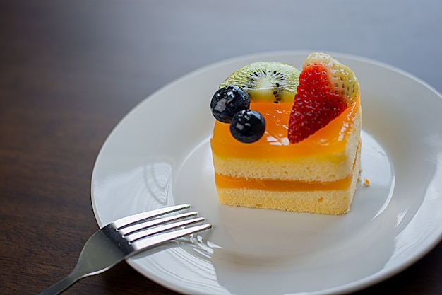 Orange cake is placed in a delightful white dish