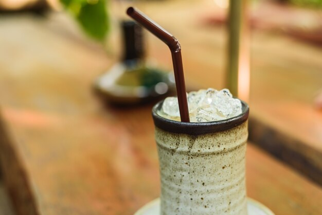 Orange cake with ice coffee on wood table