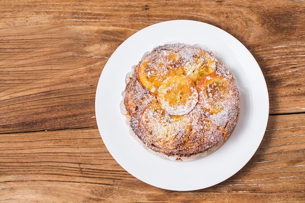 Orange cake on the wooden background