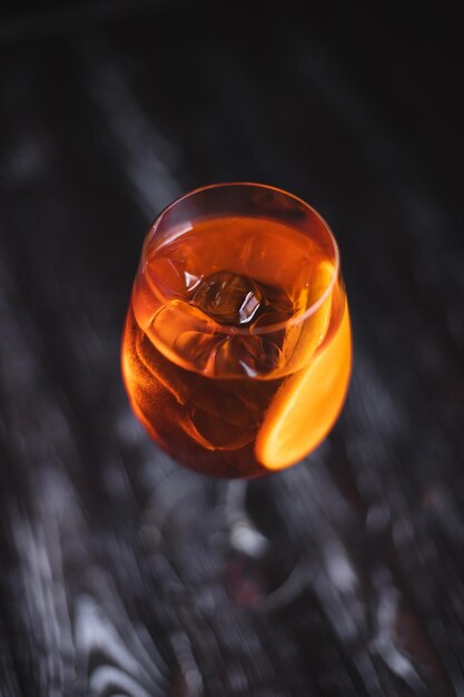 Orange cocktail with citrus and ice on a dark background