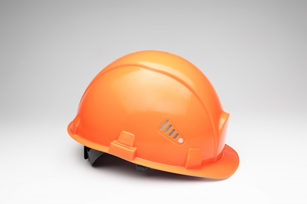 Orange construction helmet. The concept of architecture, construction, engineering, design. Copy space.