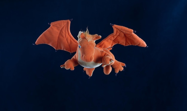 orange dragon toy isolated on black background