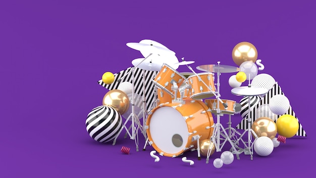 Orange drum amidst colorful balls on purple. 3d render.