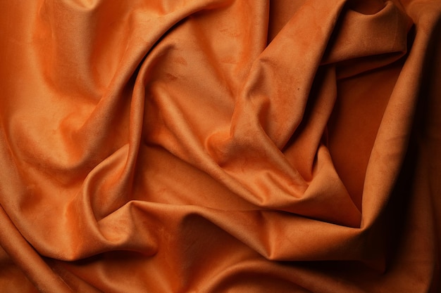 Orange fabric background view from above