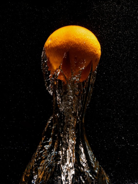 Orange falling in water