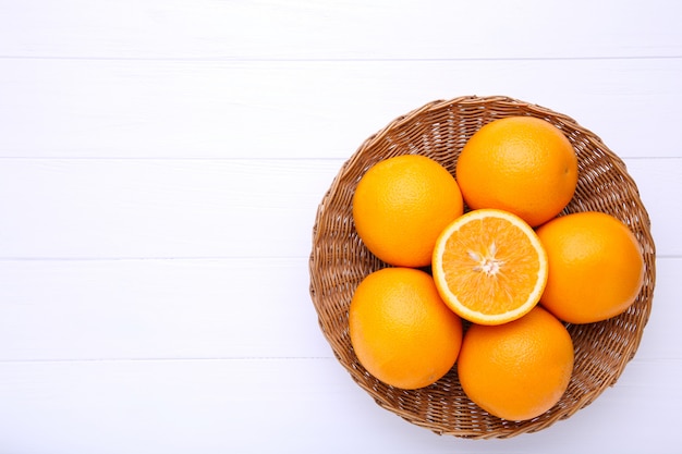 Orange fruit in basket on a white background