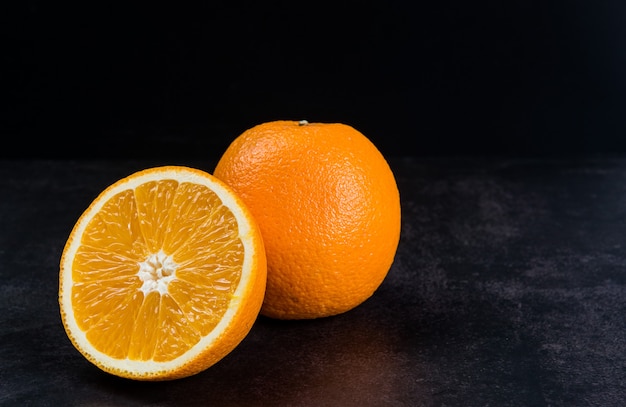 Orange fruit on the table with black background