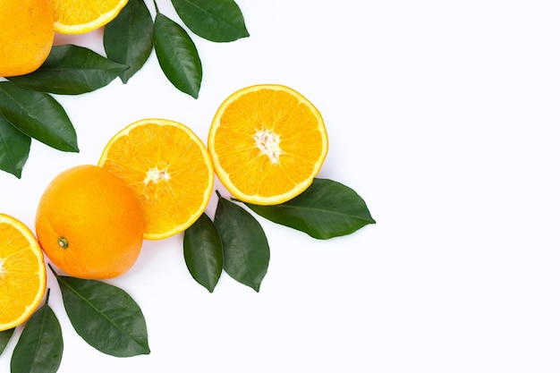 Orange fruit with green leaves on white background