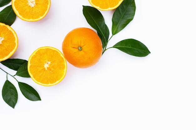 Orange fruit with green leaves on white background