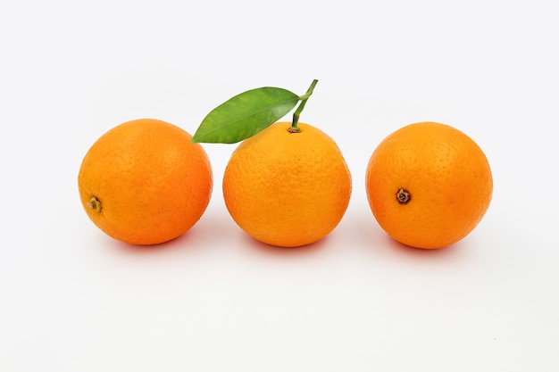 orange fruit with leaves isolated on white