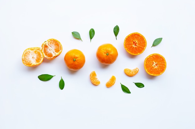 Orange fruits and green leaves on a white. 