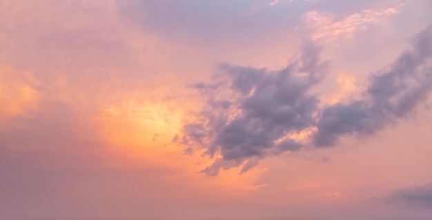 Orange gold sunset dramatic fluffy clouds at pink evening sky nature landscape