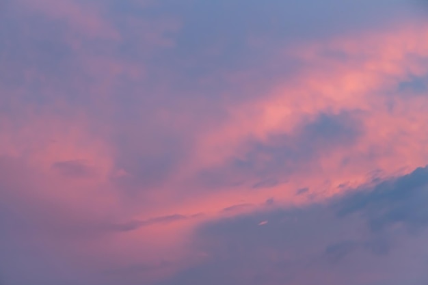 Orange gold sunset dramatic fluffy clouds at pink evening sky nature landscape