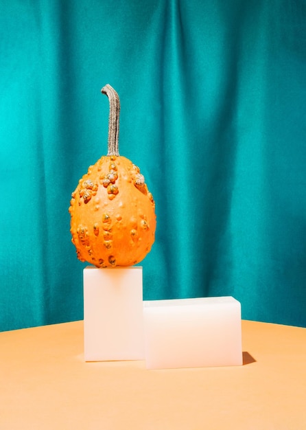 Orange gourd and podium with curtain background Product podium suitable.Autumn Halloween background