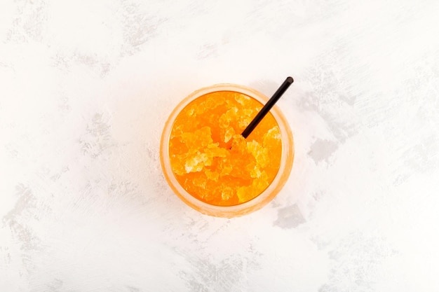 Orange Granizado in glass, top view. Refreshing Slushie drink. Sweet Citrus Shaved ice