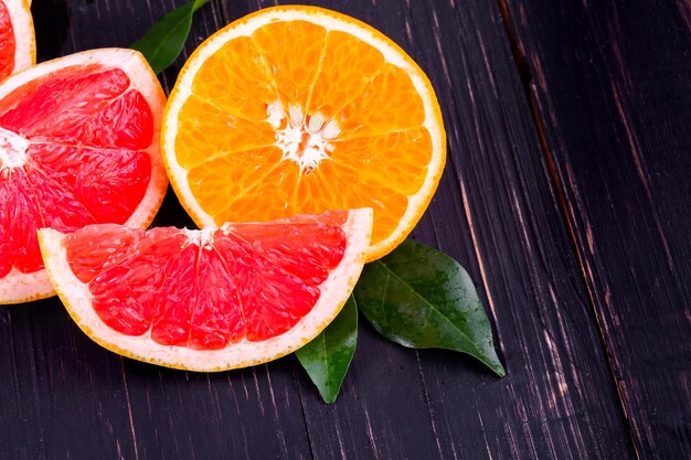 Orange and grapefruit juice On a wooden black background