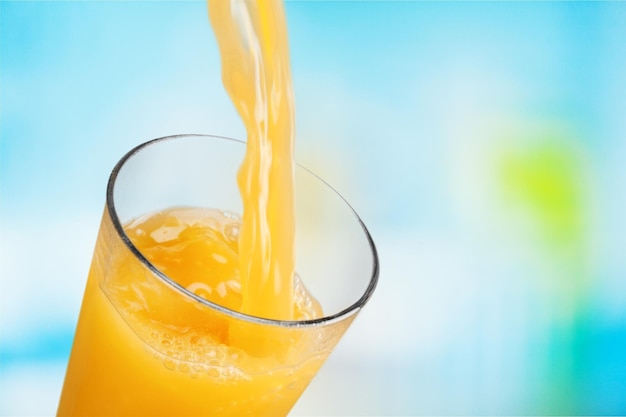 Photo orange juice glass on blur background